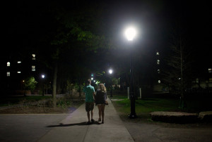 two peopel wlaking at night on college campus setting