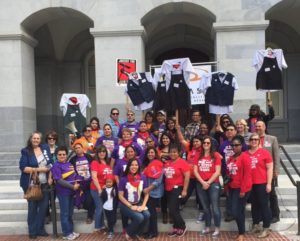 SEIU USWW members and CALCASA staff on the steps of teh California State Capitol for Demin Day. About 30 people wearing read and purple teeshirts.