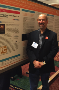 David Lee standing in front of poster on National Scan of sexual violence prevention efforts on college campuses at Safe States Alliance annual meeting