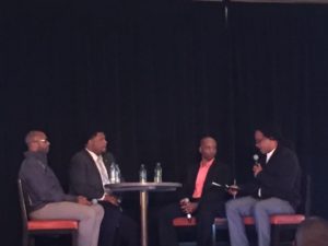 Picture of 4 men sitting around a table on the panel