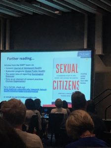A projection screen with a PowerPoint slide showing the cover of an upcoming book. The book has a white cover with the words "Sexual Citizens" in red font. 